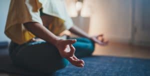 woman meditating on her floor 