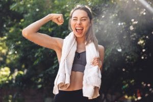 young woman flexing after her outdoor workout