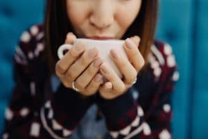 upclose of woman sipping coffee out of her mug