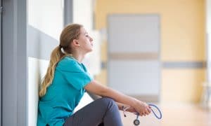 nurse critical thinking in the hallway about her shift and patients.