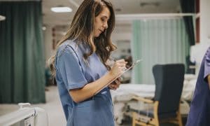 nurse reviewing chart and organizing what needs to happen.