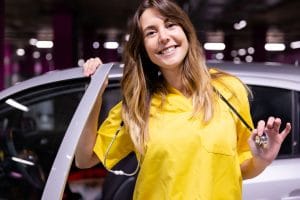 young travel nurse smiling and getting out of her car