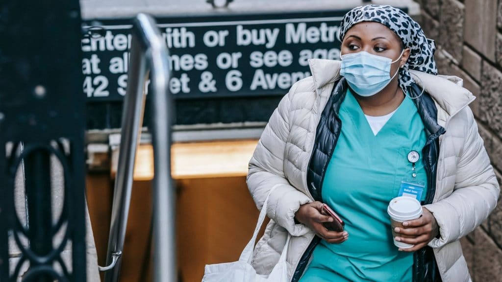 nurse getting off the subway