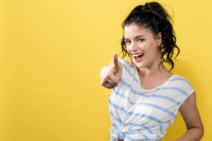 Girl giving thumbs up and is smiling